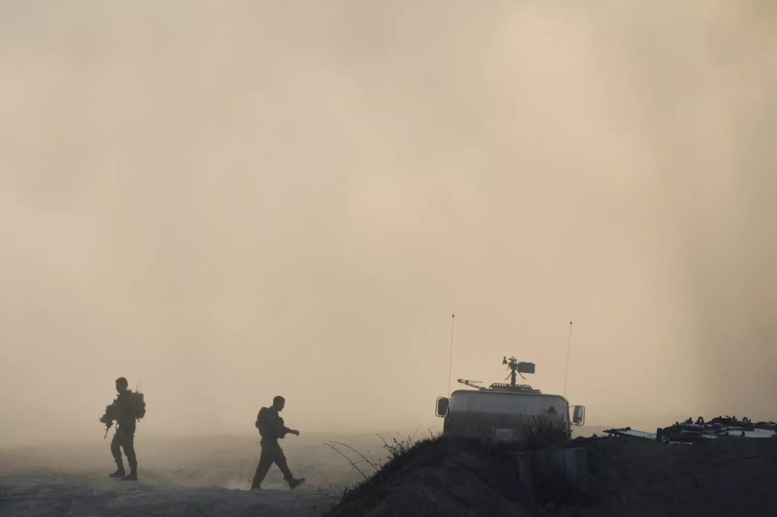 Israeli soldiers walk along the border of the Gaza Strip in southern Israel, Wednesday, Aug. 6, 2025. (AP Photo/)