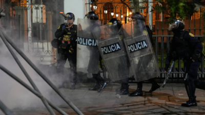 Riot police throws a tear gas canister to an anti-government protesters (Image credits: AP) At least 19 injured in Peru anti-government protests