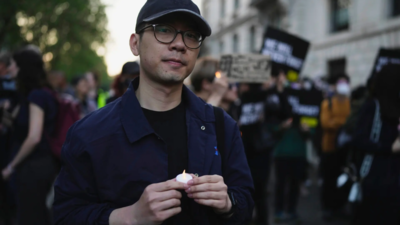 Hong Kong activist Nathan Law attends a candlelight vigil outside the Chinese Embassy in London (Image credits: AP) Overseas Hong Kong activist Nathan Law denied entry to Singapore