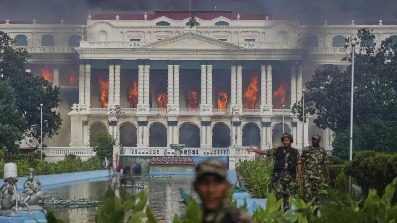 Nepalese army soldiers disperse protesters from Singha Durbar, the seat of Nepal's government's various ministries and offices, after it was set on fire during a protest against a social media ban and corruption in Kathmandu, Nepal.