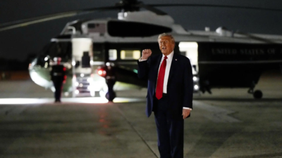 File photo: US President Donald Trump gestures to members of the media before walking to Marine One (Picture credit: AP) 'Risk of an airborne collision': Man charged for pointing laser at Marine One with Donald Trump; detained