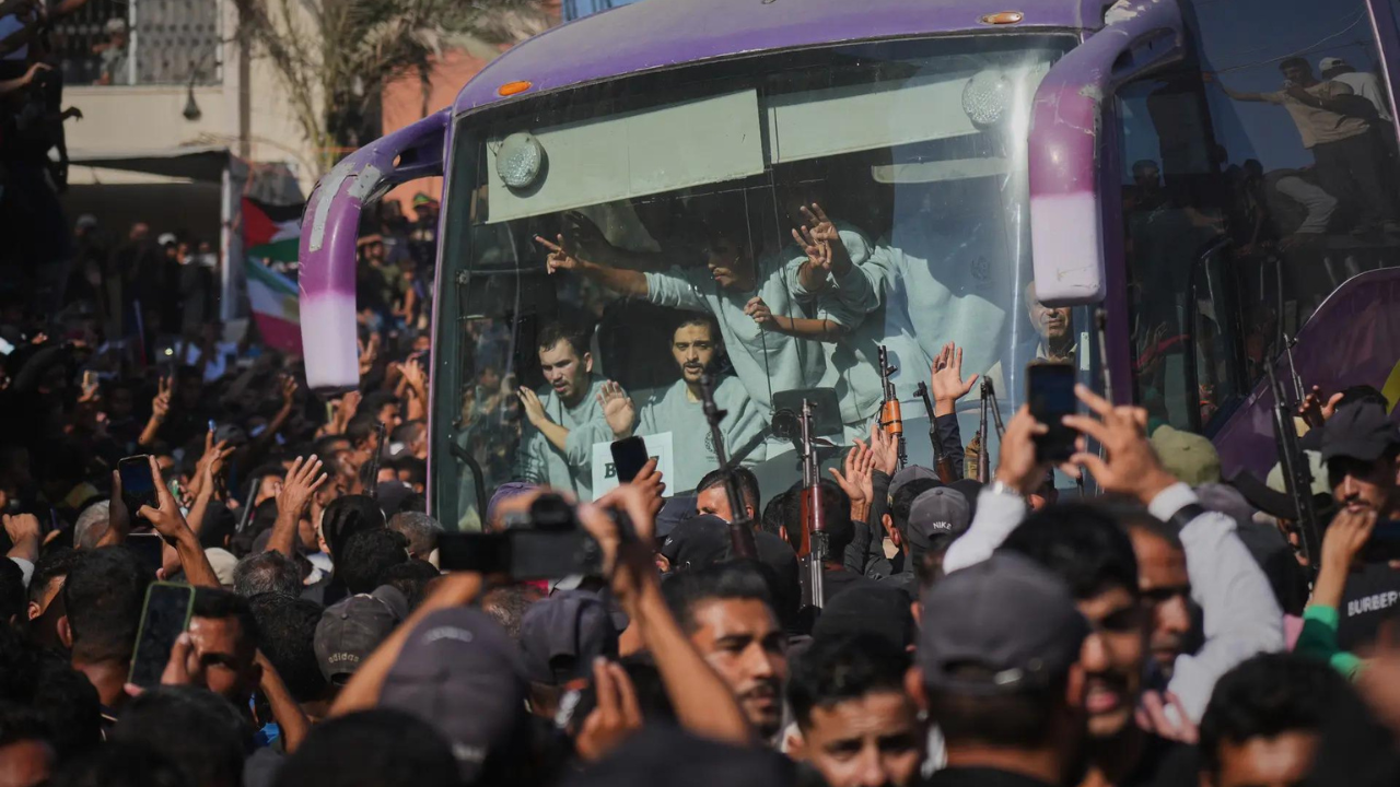 People greet freed Palestinian prisoners arriving on buses in the Gaza Strip (AP photo) .