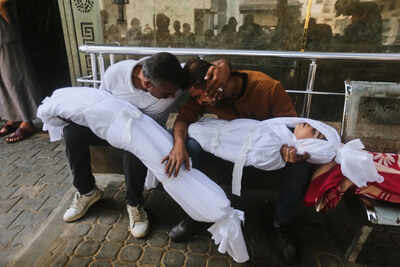 Mahmoud Shakshak, right, holds the bodies of his 5-year-old son, Fadi, and his 8-year-old daughter, Sara, who were killed in an Israeli army strike, at Shifa Hospital in Gaza City Wednesday, Oct. 29, 2025. (AP Photo/Yousef Al Zanoun) After 104 deaths, Israel says Gaza 'ceasefire' back on — but for how long?