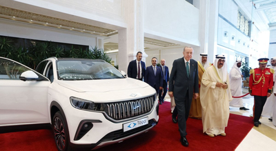 This handout photograph shows President Recep Tayyip Erdoğan (C-L) presenting the Turkish-made Togg electric car to Kuwait's Emir Sheikh Mishal Al Ahmad Al Sabah (C-R) in Kuwait City, during his official visit to Kuwait, Oct. 21, 2025. ( AFP Photo via Turkish Presidency Press Office) Turkish President Erdoğan gifts Turkish-made electric car to Kuwaiti Emir Al-Sabah during Gulf visit
