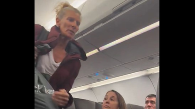 The alleged disruptor apologised as she was being taken out of the plane and then said: 'We live in a fascist country': American Airlines flight diverted over passengers' outburst; 4 Congressmen were flying to vote on shutdown