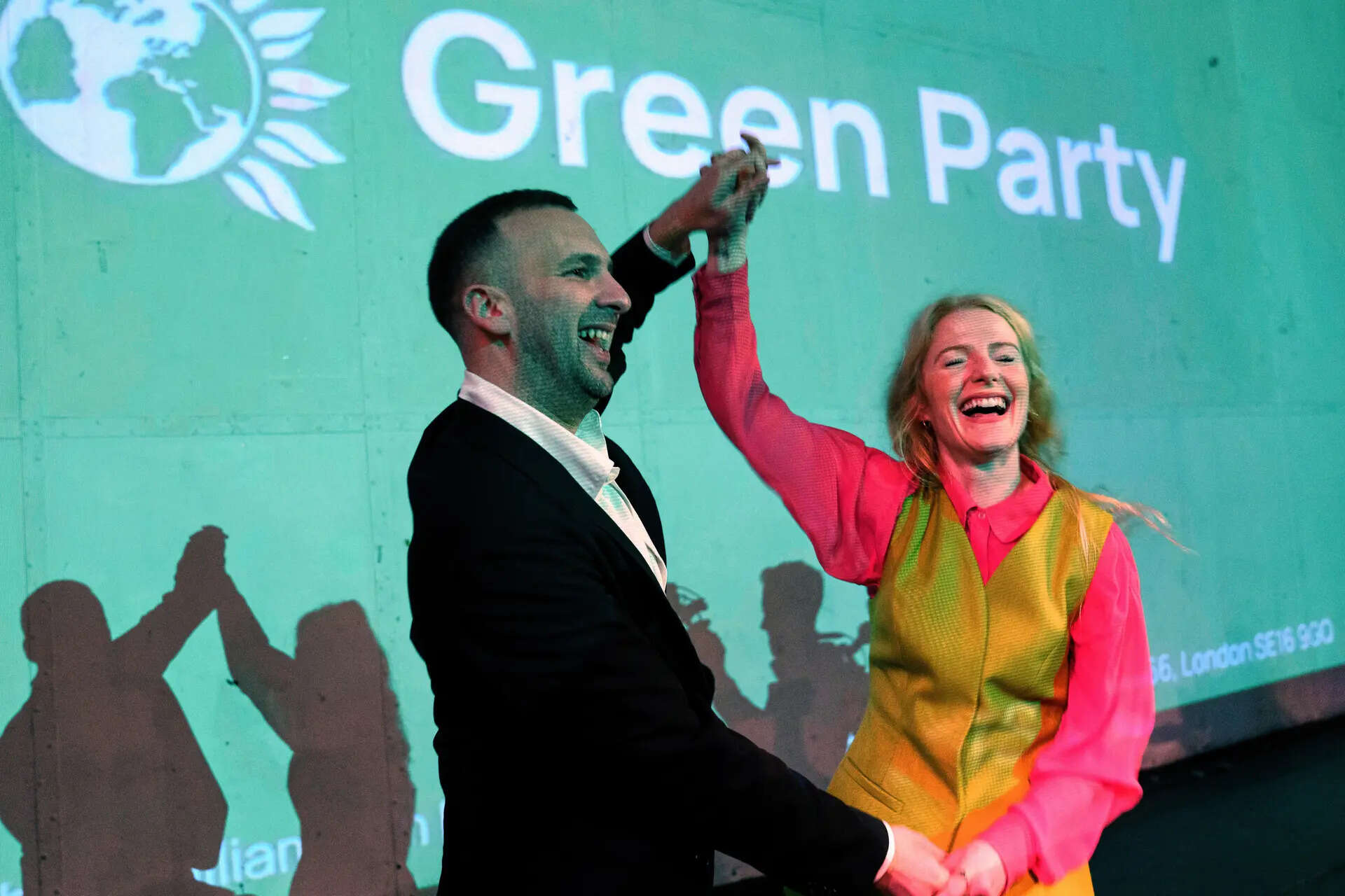 Green Party candidate Hannah Spencer, right, celebrates with party leader Zack Polanski at a volunteer thank you event after winning the Gorton and Denton by-election, Manchester, England, Friday, Feb. 27, 2026. (AP Photo/Jon Super) The Green Swing