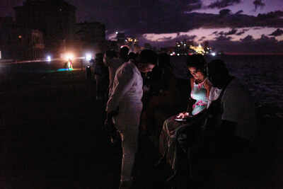 People spend the night in the dark on the Malecon during a blackout in Havana, Cuba, Saturday, March 21, 2026. (AP Photo/Ramon Espinosa) Cuba in darkness again: US oil blockade forces another blackout this week as Havana turns to flashlights