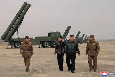 In this photo provided by the North Korean government, its leader Kim Jong Un, center right, and his daughter, center left, attend a live-fire test of multiple rocket launch systems, at an undisclosed place in North Korea Saturday, March 14. (Korean Central News Agency/Korea News Service via AP) Kim Jong Un, daughter oversee test of North Korea's 'deadly yet attractive' rocket launchers