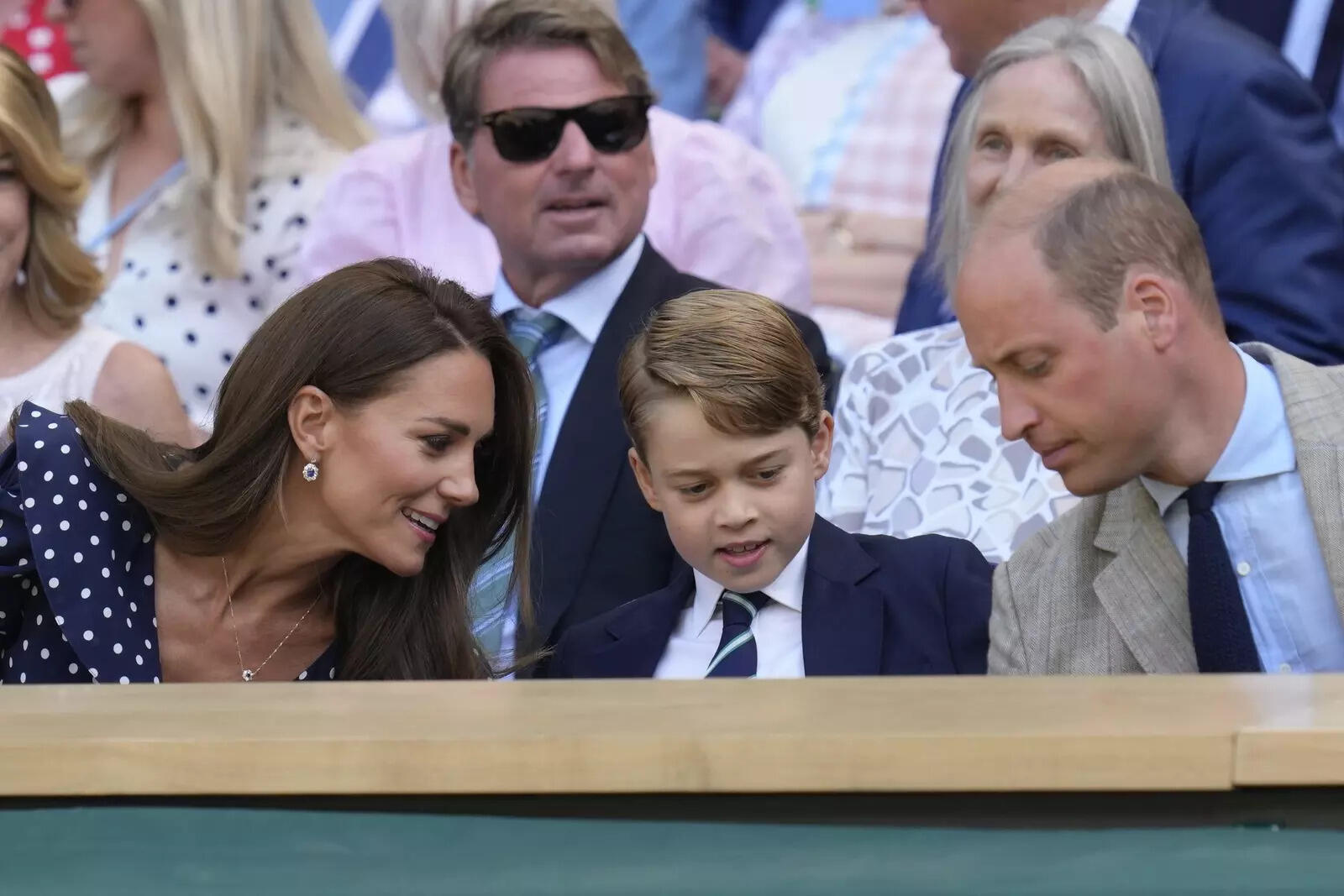 Prince George experienced a memorable moment at Wimbledon's centenary celebration, holding the champion's trophy for the first time. From left, Britain's Kate, Duchess of Cambridge, Prince George and Prince Willia...