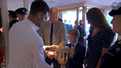 During a post-match meeting with champion Novak Djokovic, Prince George was offered the trophy, leading to a humorous moment as his father Prince William playfully warned him not to drop it. Image Credits: X/@Wimbledon (Screenshot) ‘Don't drop it,’ said Prince William as Novak Djokovic handed the 2022 Wimbledon trophy to Prince George