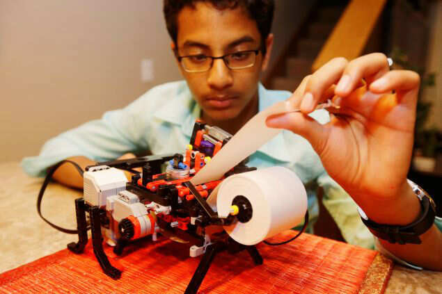 Shubham Banerjee working on his lego robotics braille printer at his home in Santa Clara, California| Image Credit: AP Shubham BanerjeE