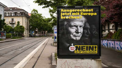 A poster reading Will Switzerland cap its population at 10 million? What it means for immigrants
