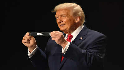 President Donald Trump holds up USA after drawing from a pot of balls during the draw for the 2026 soccer World Cup at the Kennedy Center in Washington, Friday, Dec. 5, 2025. (Mandel Ngan/Pool Photo via AP) Paraguay's president will be at USA's FIFA World Cup 2026 opener, but is Donald Trump attending?